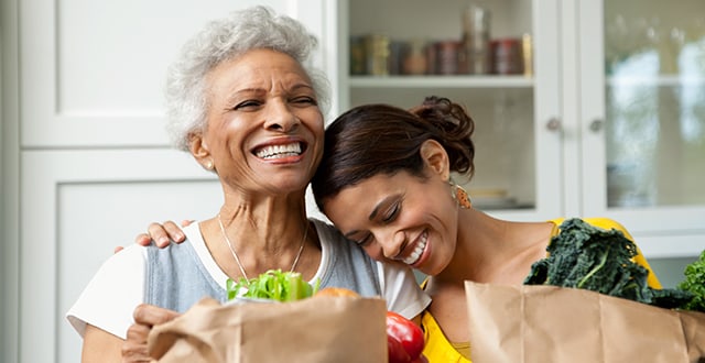 an older woman and her daughter with groceries