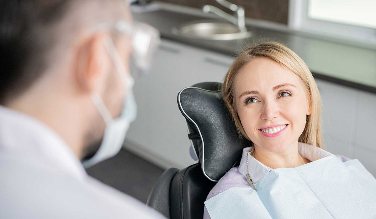 Woman smiling at dental hygienist