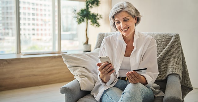 woman holding smartphone and card