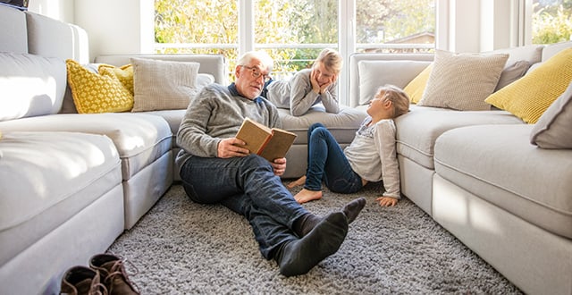 Family hanging out on living room floor